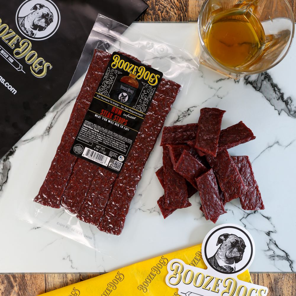 4 OZ PACK OF RUM INFUSED JERKY STYLE STEAK STRIPS WITH CUT PIECES TO THE SIDE