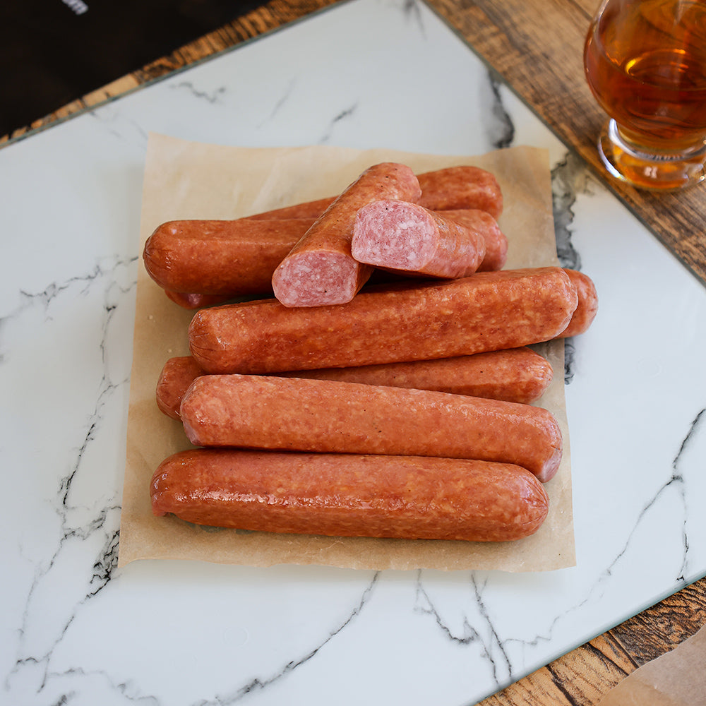 CUT LINKS OF BOURBON INFUSED HOT DOGS