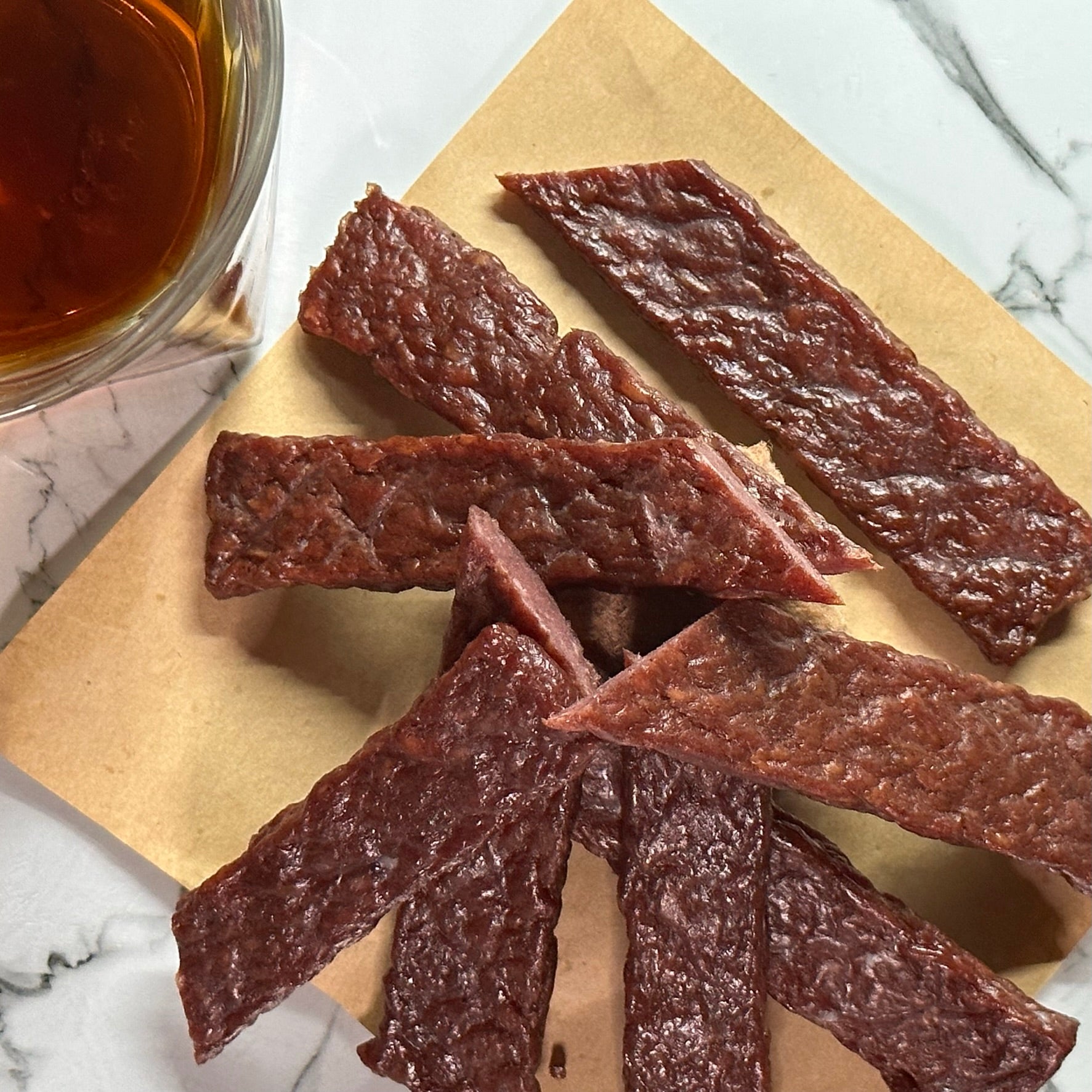 CUT PIECES OF RUM INFUSED JERKY STYLE STEAK STRIPS