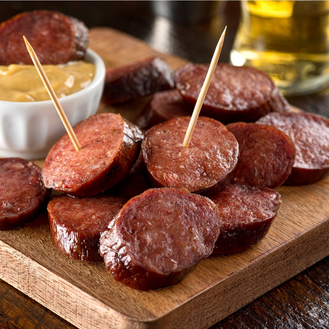 SLICED BOURBON INFUSED SAUSAGE ON APPETIZER CUTTING BOARD